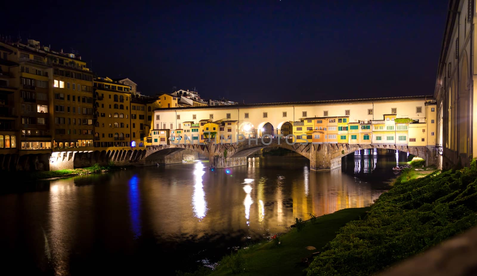Pisa, Italy - August 11, 2013: Famous Ponte Vecchio night view over Arno river in Florence, Italy