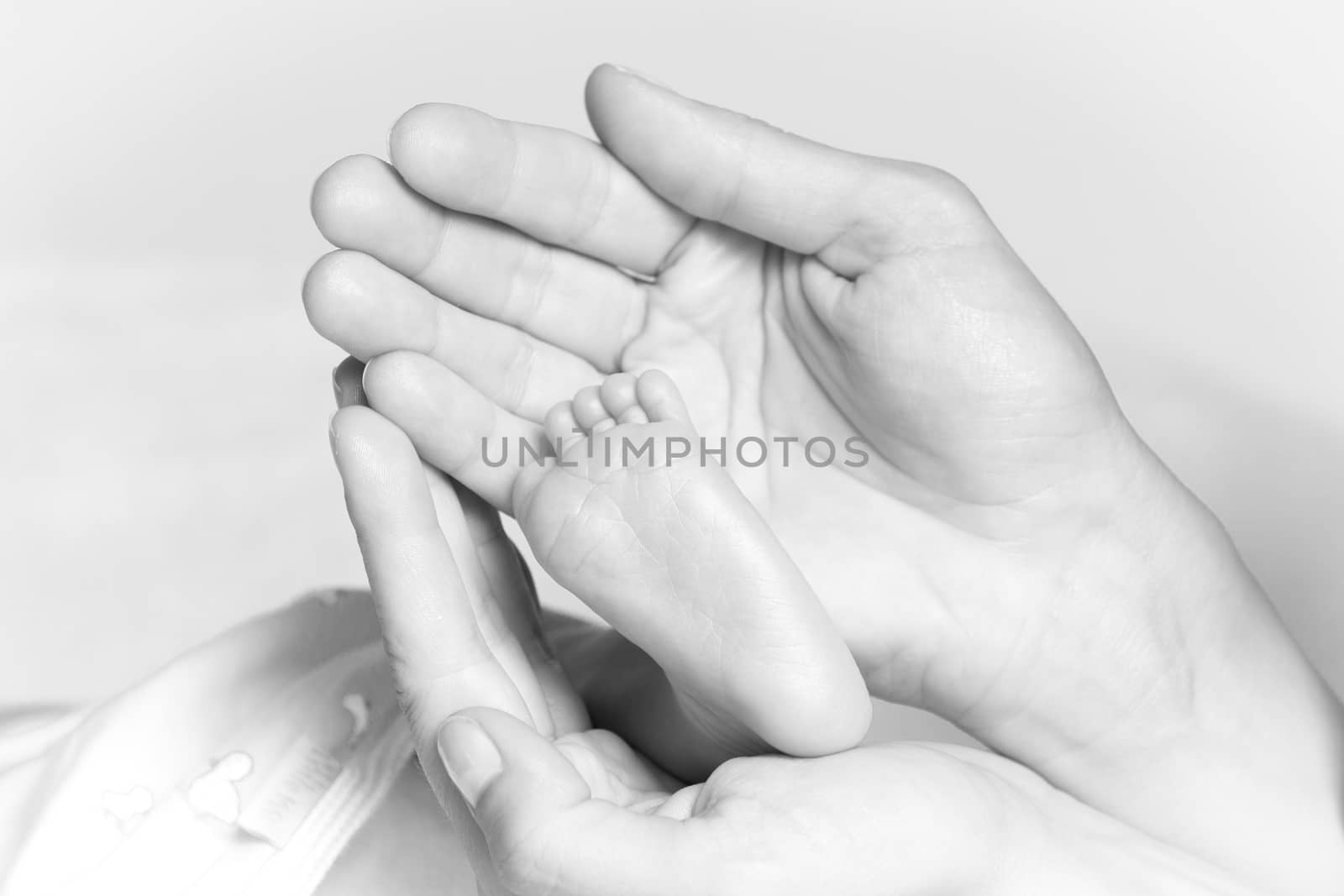 Closeup at a tiny foot of a newborn