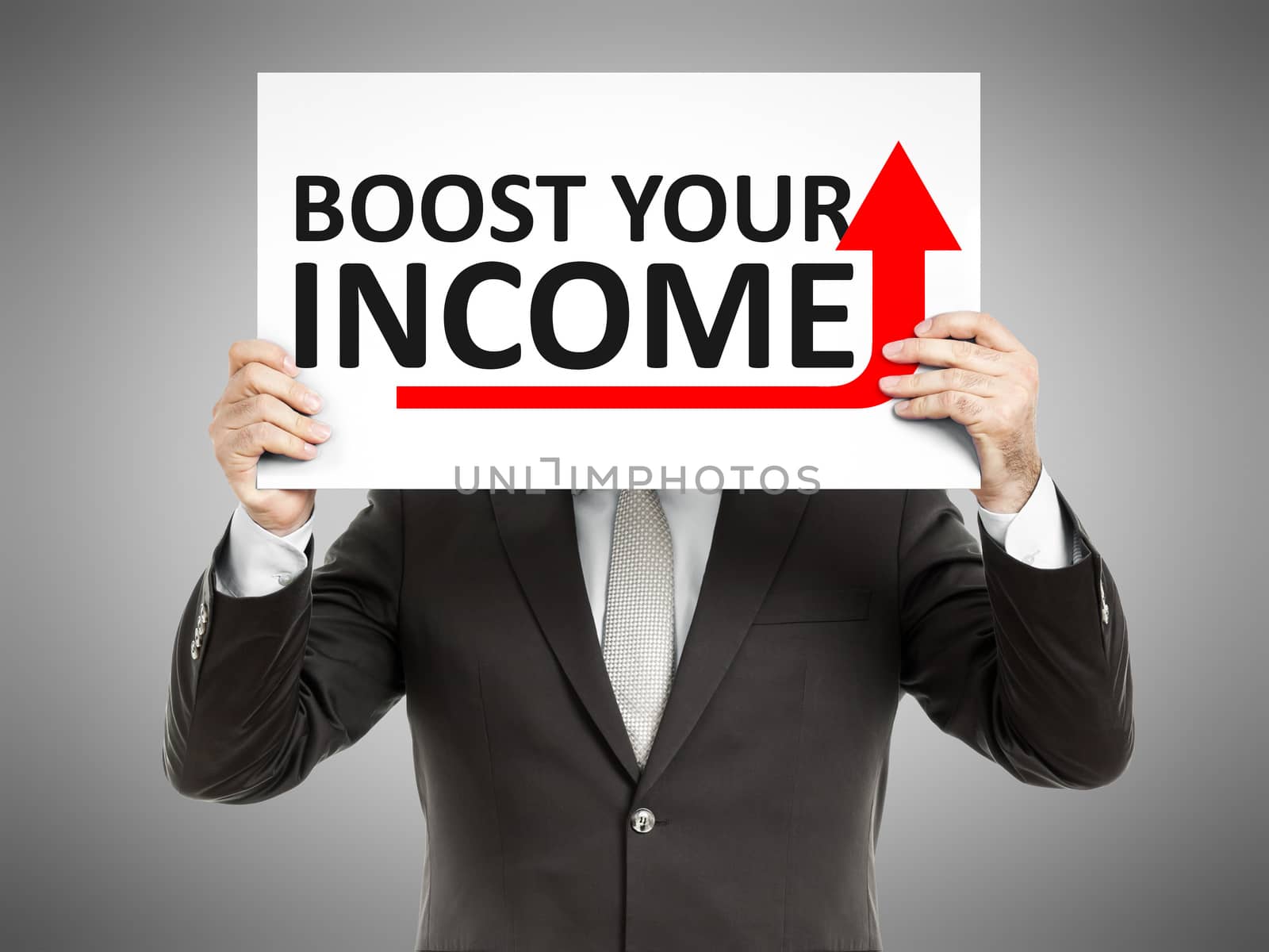 A business man holding a paper in front of his face with the text boost your income