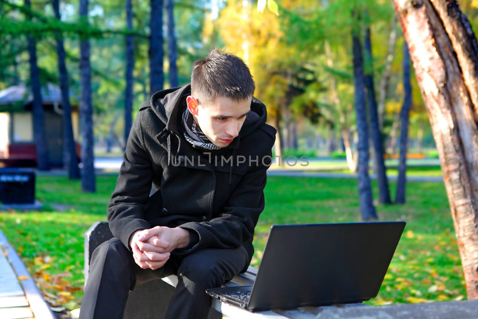 Young Man with Laptop outdoor by sabphoto