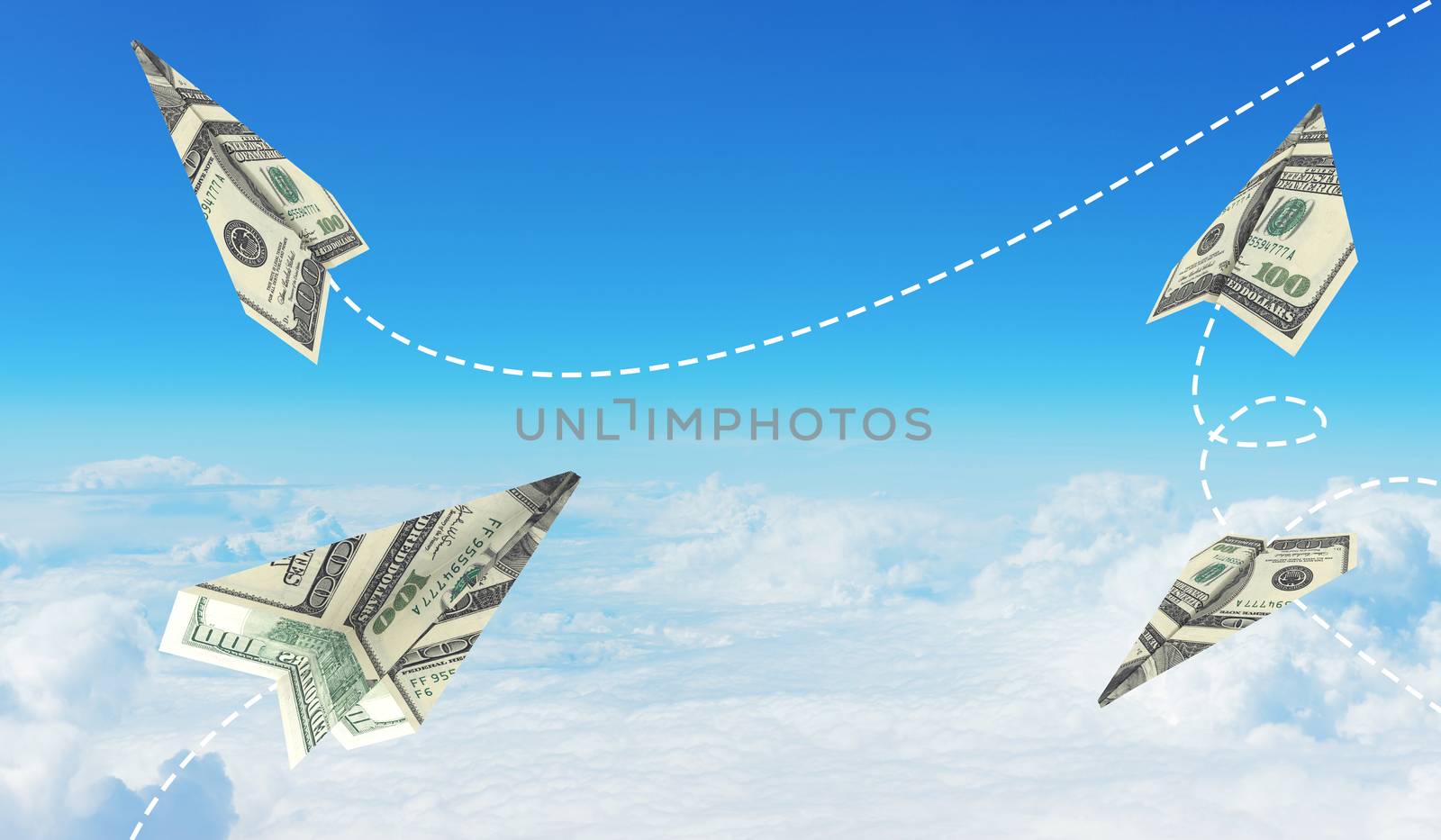 Paper airplanes made of hundred dollar bills. Sky and clouds in the background