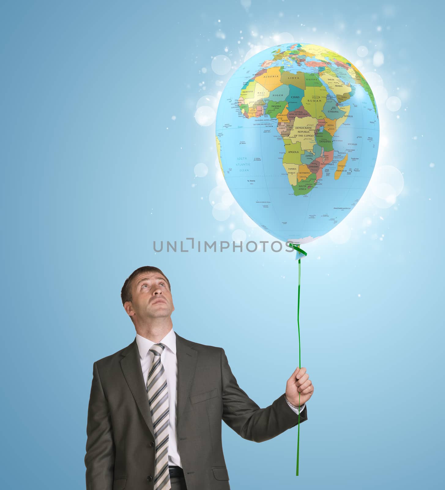 Businessman holding balloon with the image of world map by cherezoff