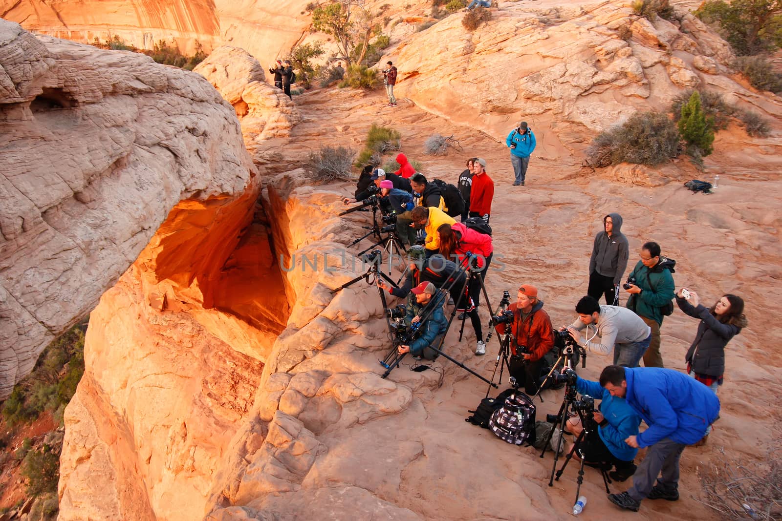 Photographers and tourists watching sunrise at  Mesa Arch, Canyonlands National Park, Utah