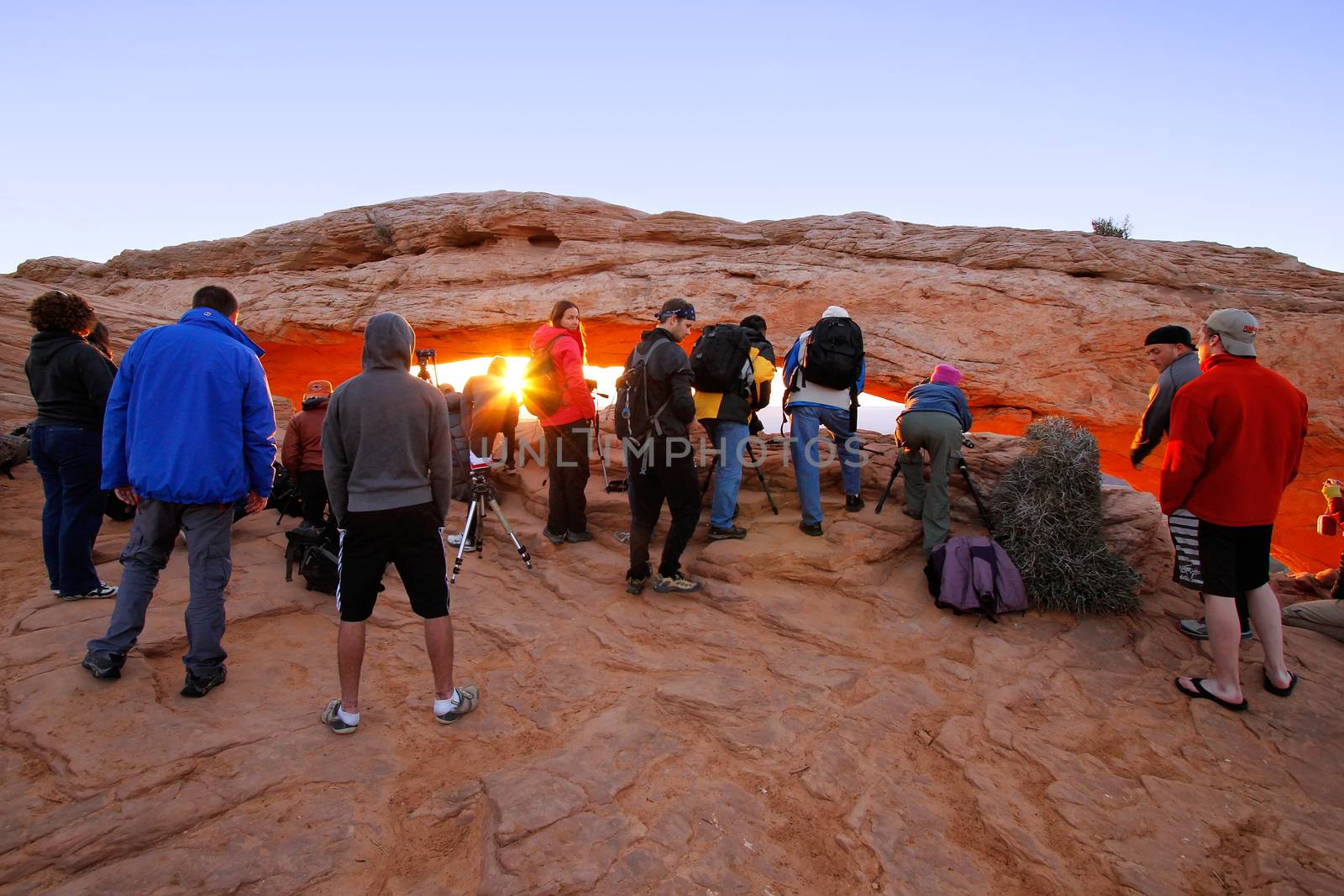 Photographers and tourists watching sunrise at  Mesa Arch, Canyonlands National Park, Utah