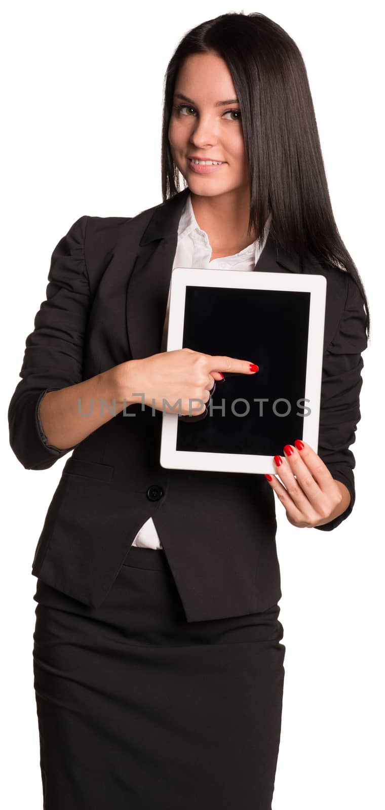 Beautiful businesswoman in suit holding tablet and points finger at his blank screen. Isolated on white background