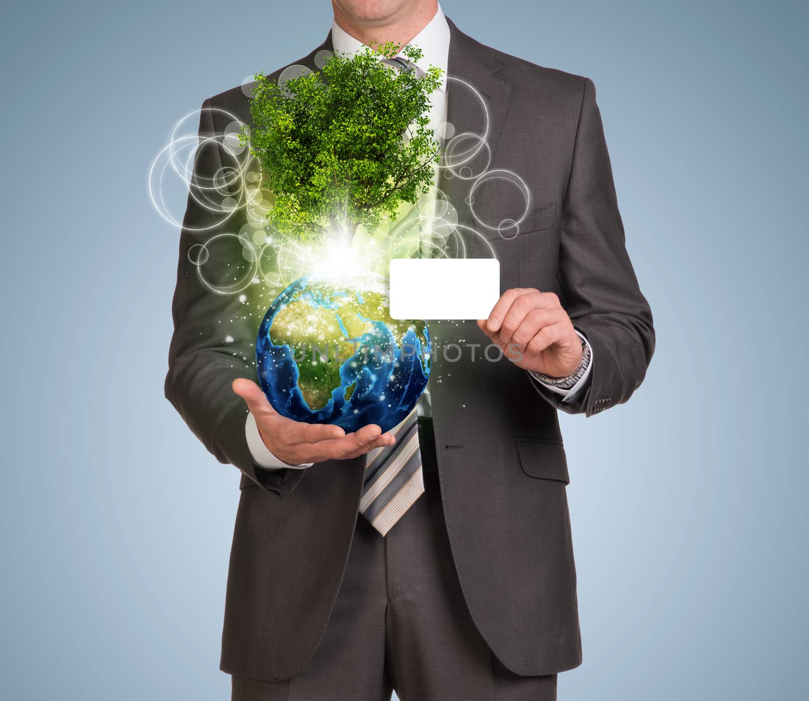 Businessman in suit hold empty card and Earth with tree. Elements of this image are furnished by NASA