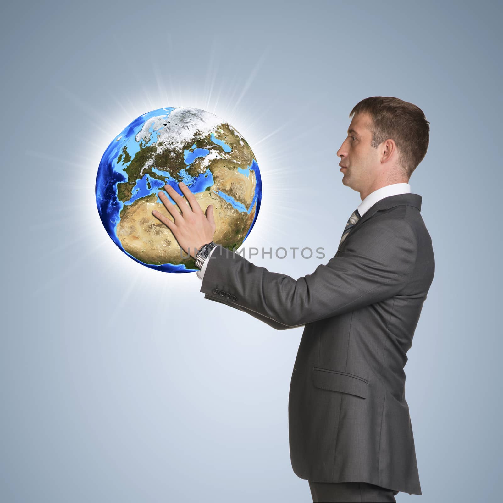 Businessman in suit hold Earth. Elements of this image are furnished by NASA