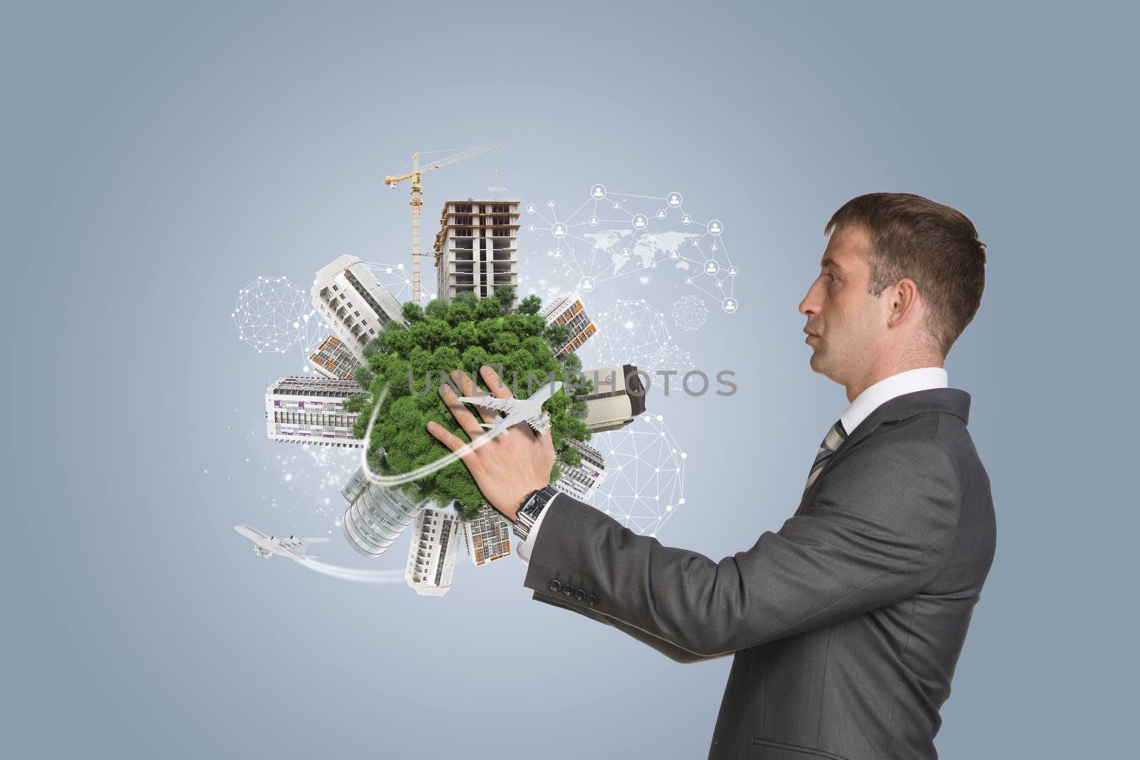 Businessman in suit hold Earth with buildings. Blue background
