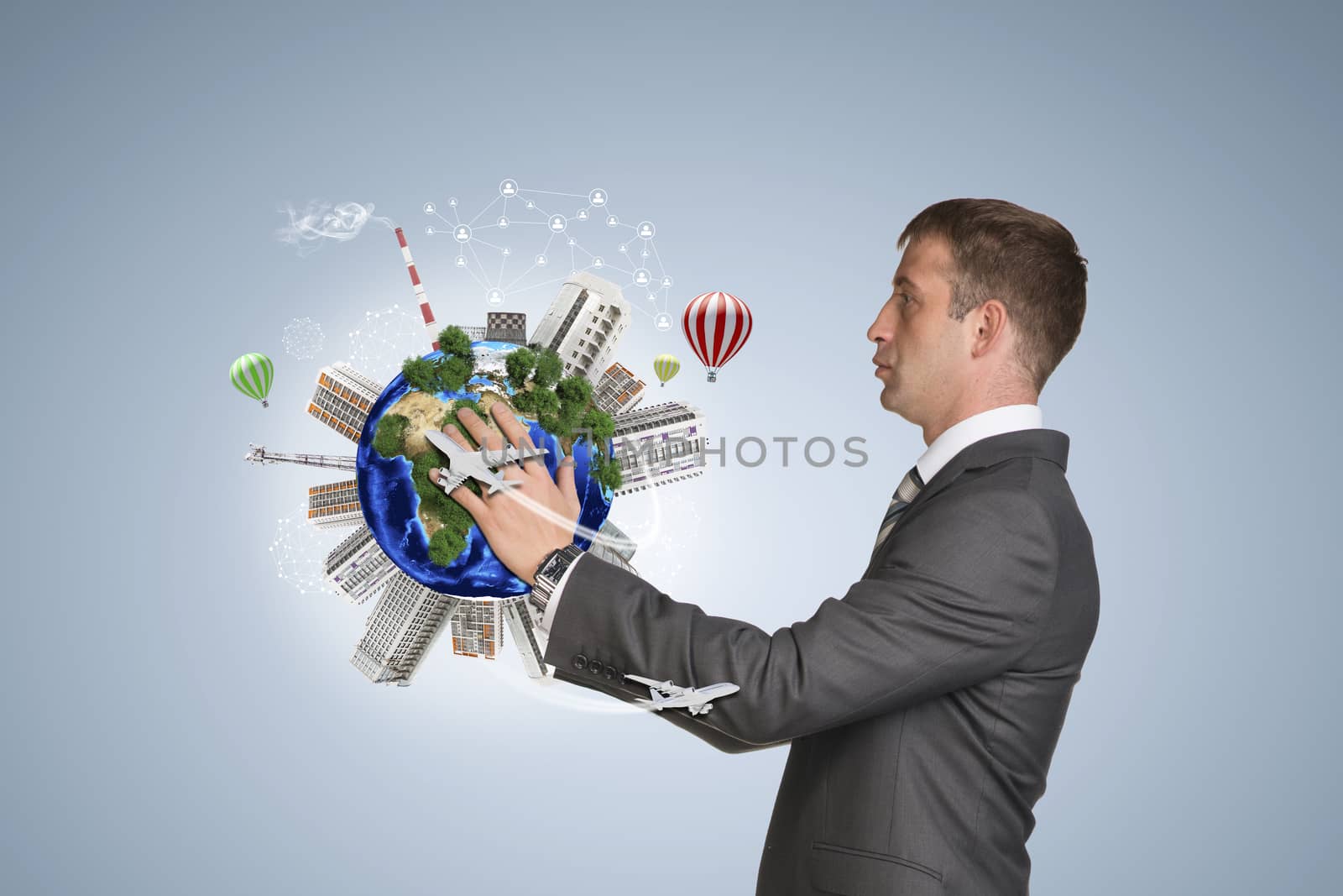 Businessman hold Earth with buildings by cherezoff