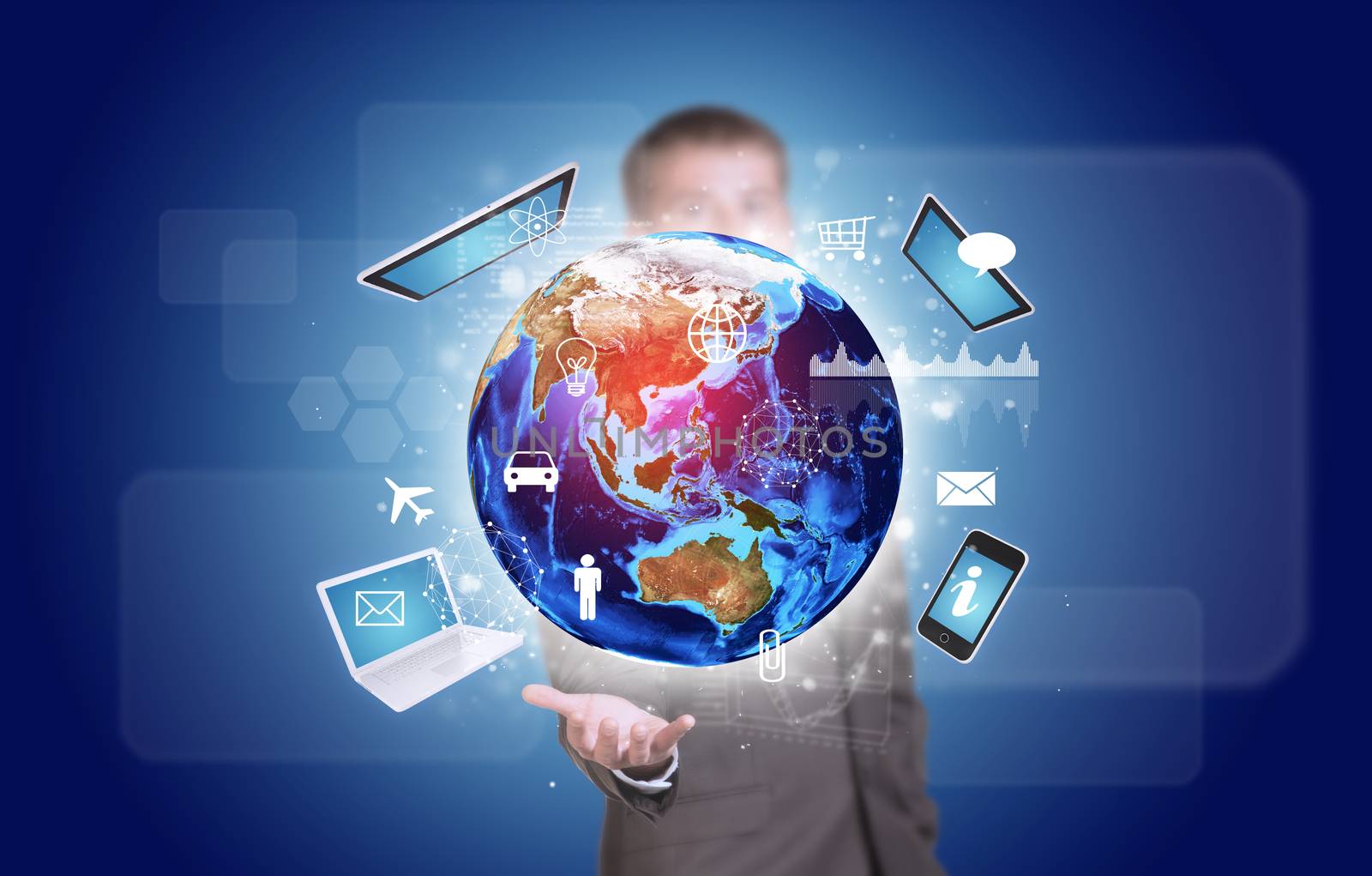 Businessman in suit hold Earth with electronics, graphs and icons by cherezoff