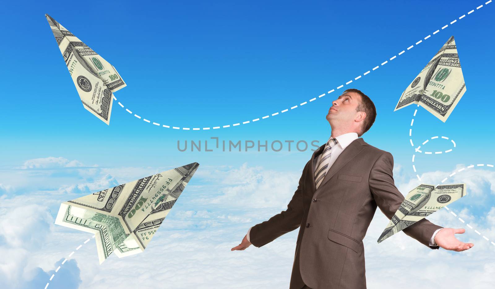 Businessman with paper airplanes made of hundred dollar bills by cherezoff