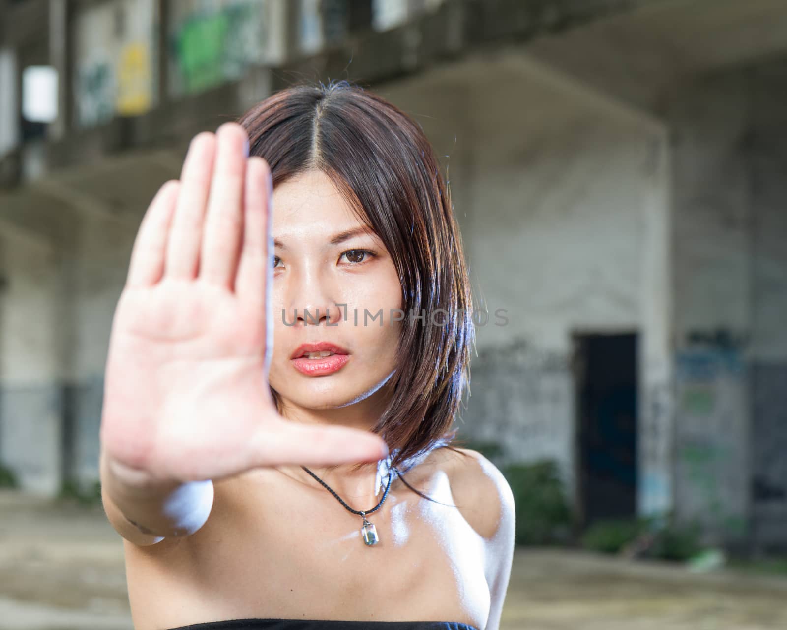 Chinese woman gesturing no with hand by imagesbykenny
