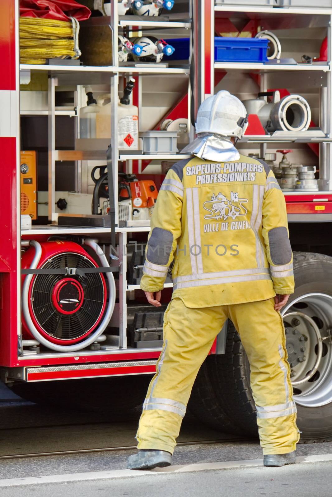 Firefighter wearing helmets standing next to fire truck, Geneva, Switzerland