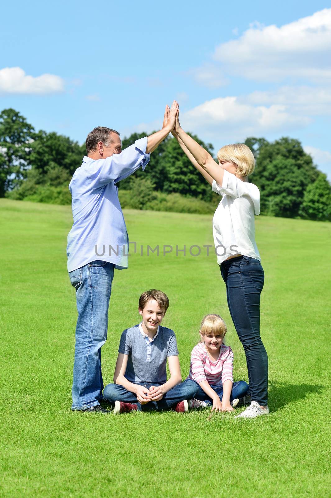 Parents playing game with children in field