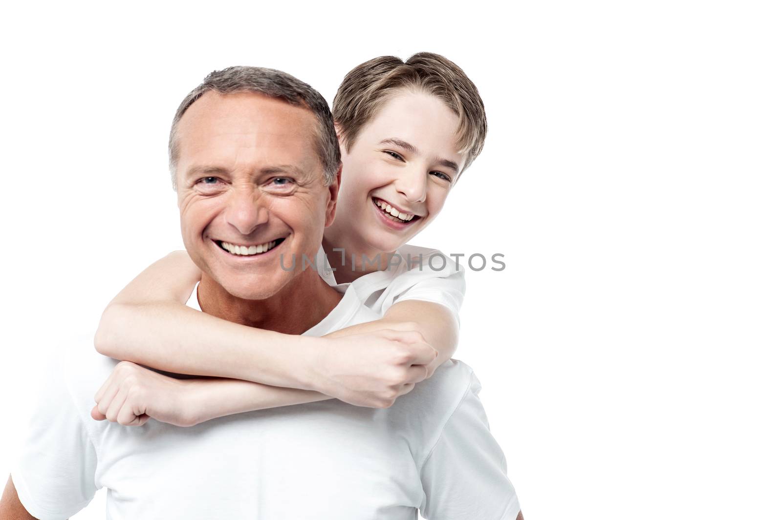 Smiling father holding his son on his shoulders