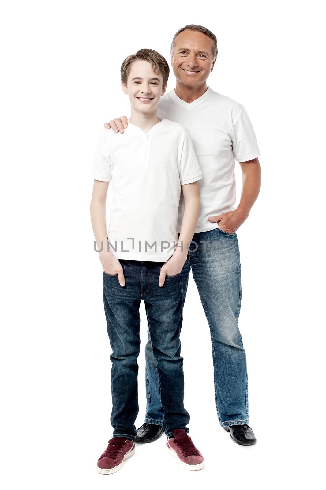 Smiling father and son posting together by stockyimages