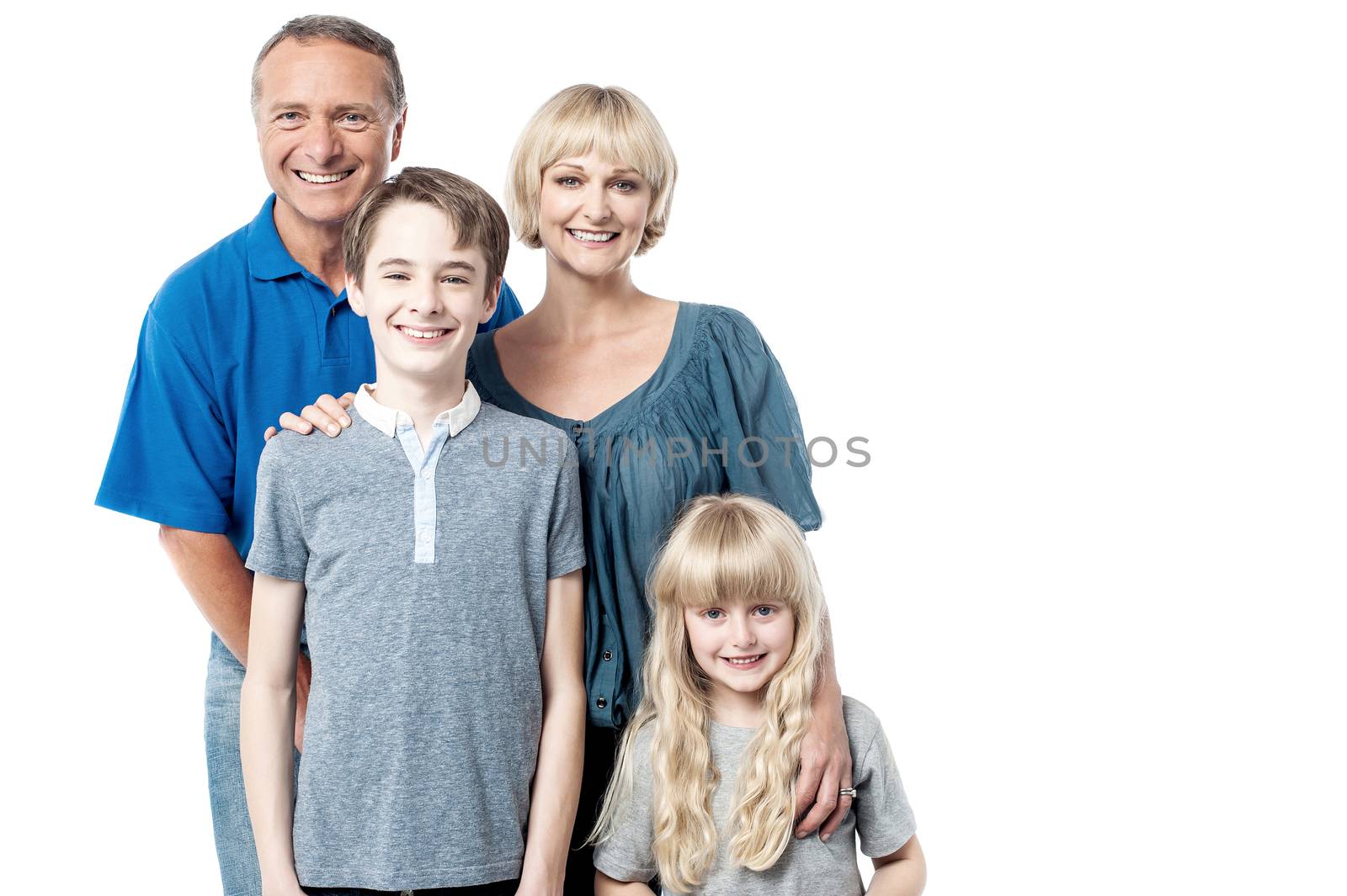 Cheerful family of four members posing together 