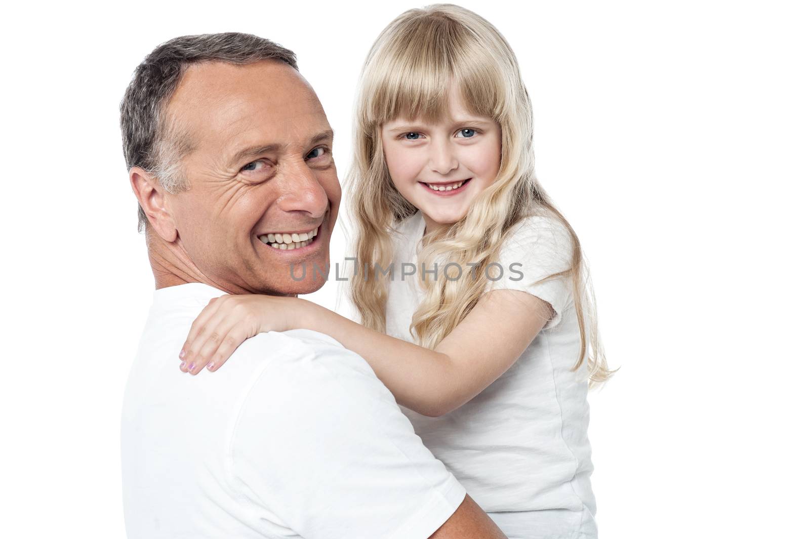 Smiling father holds the little daughter in his arms