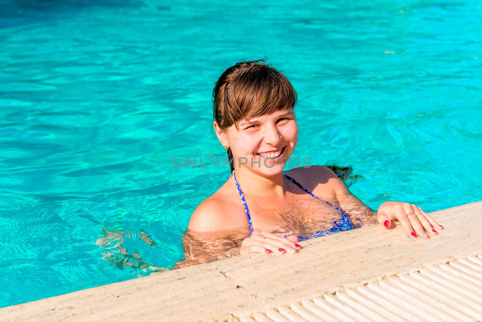 happy young woman floating in the pool