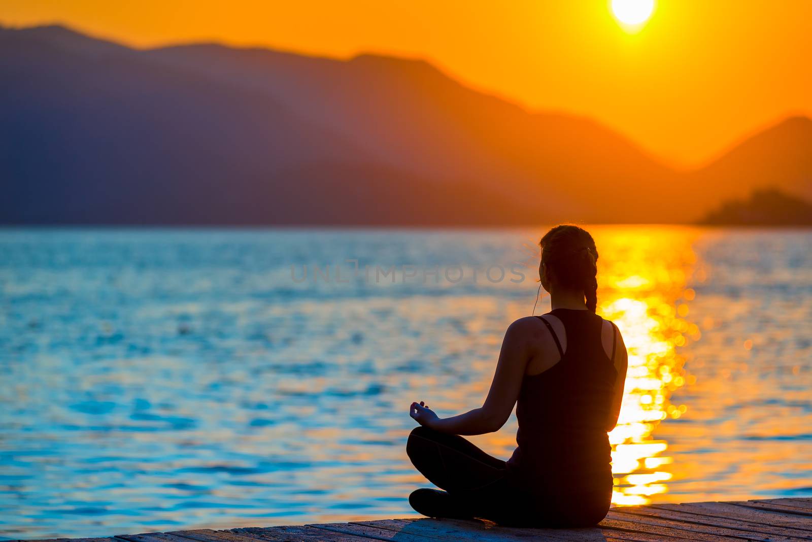 girl in lotus position admiring the rising sun by kosmsos111