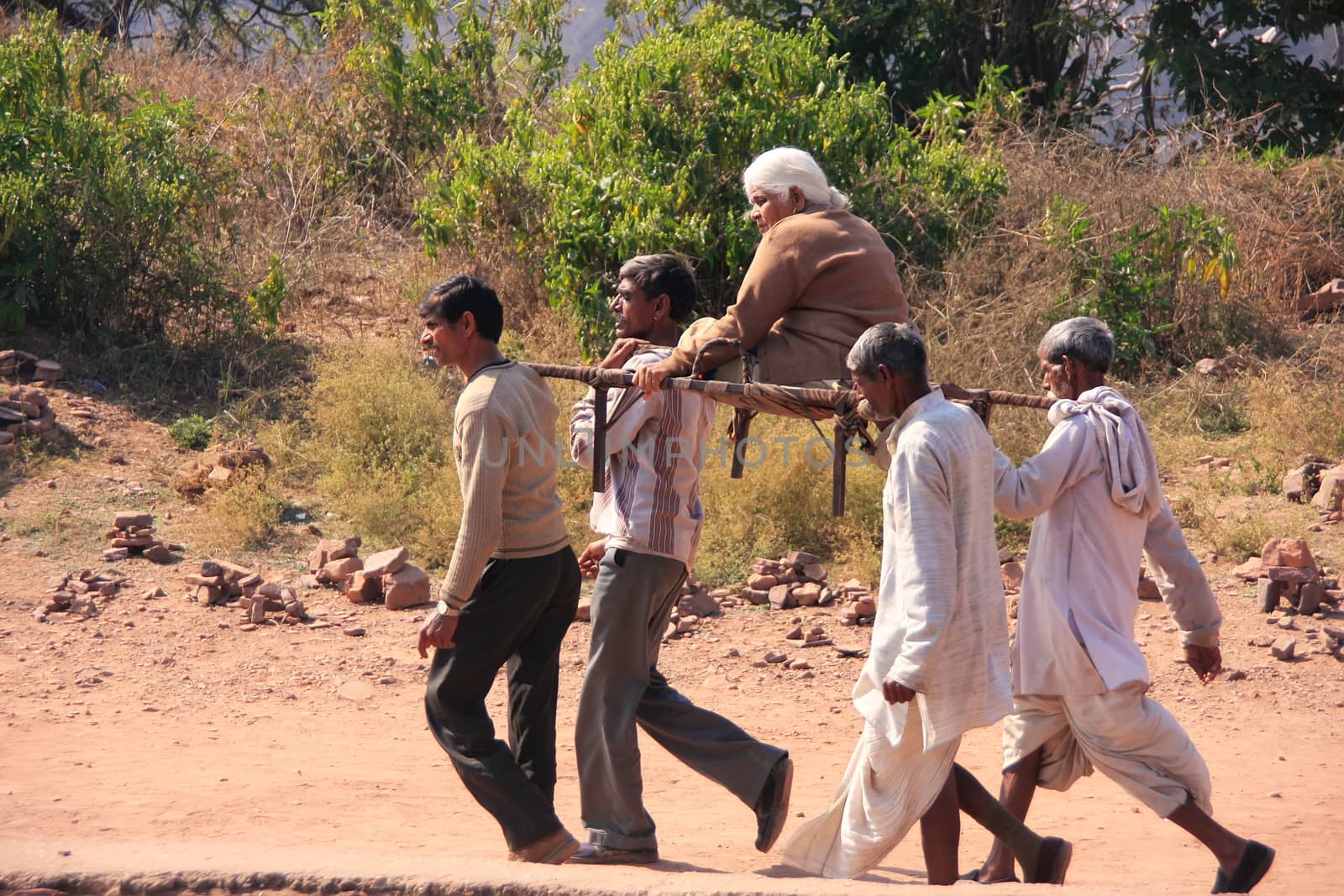 Local men carrying old woman at Ranthambore Fort, India by donya_nedomam