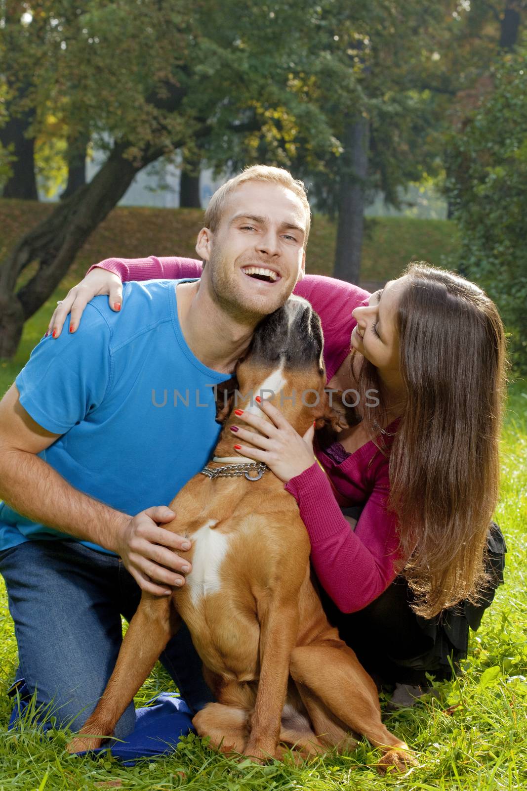 Happy Young Couple with Dog by courtyardpix