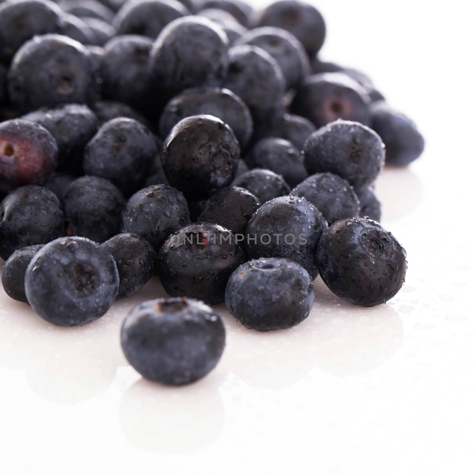 Picture of lots of blueberries over a white background