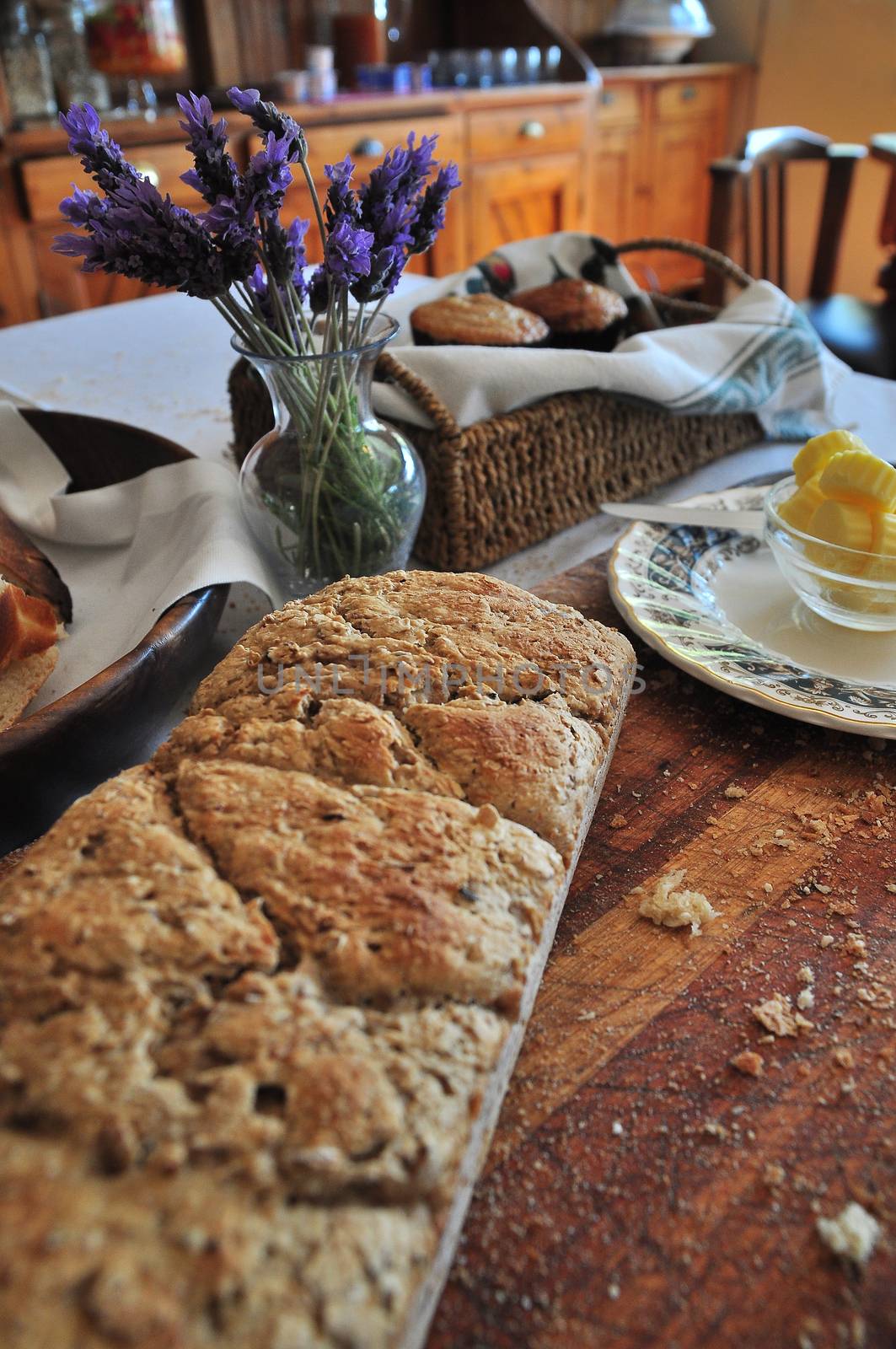 Home baked fresh wholegrain bread on cutting board laid out for breakfast table.