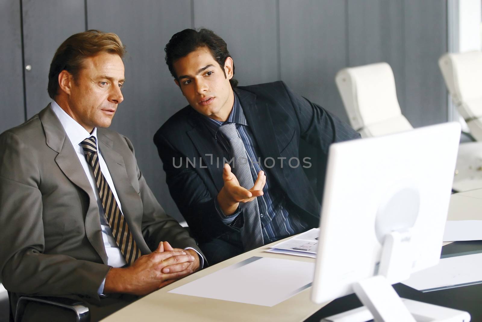 Portrait of a group of business men working together at a meeting