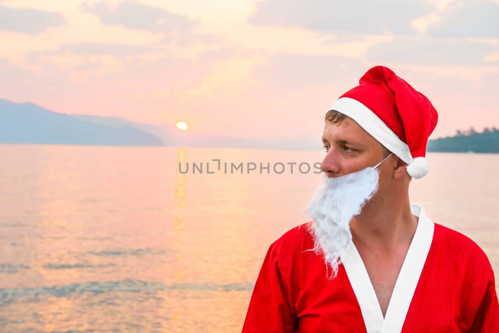 a man dressed as Santa Claus on the sea by kosmsos111