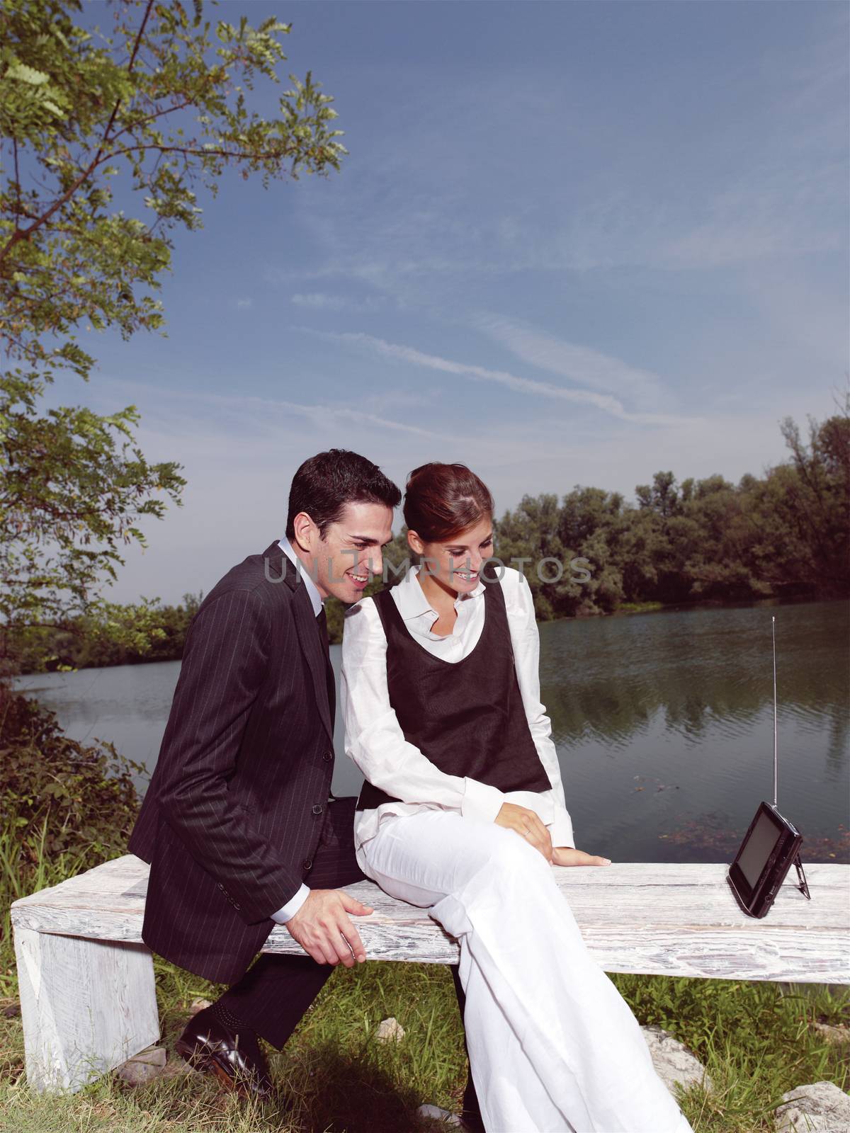 Beautiful young people using PDA outdoors 