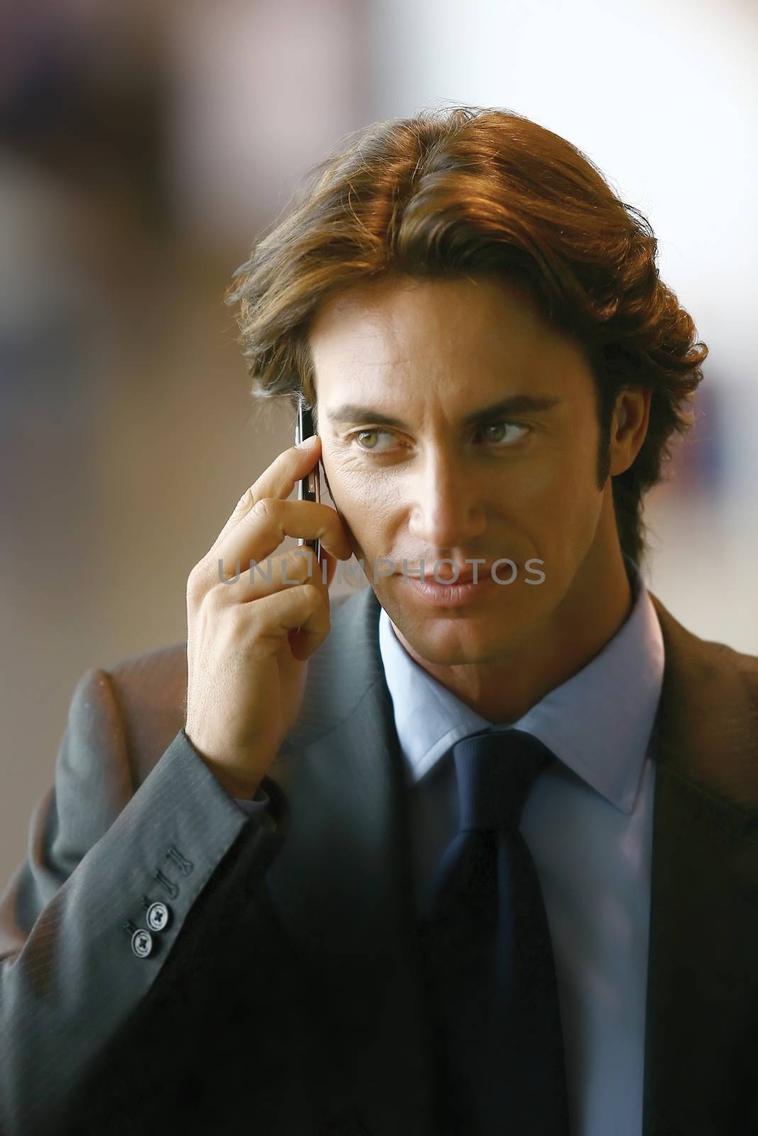 Handsome young businessman talking on mobile phone