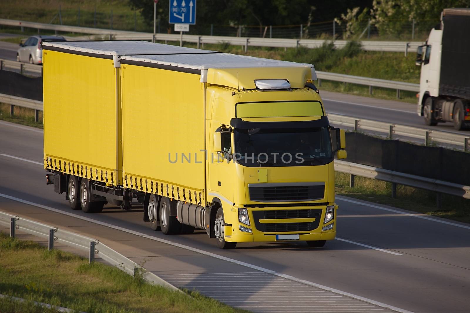 Yellow trucks roaring on the highway