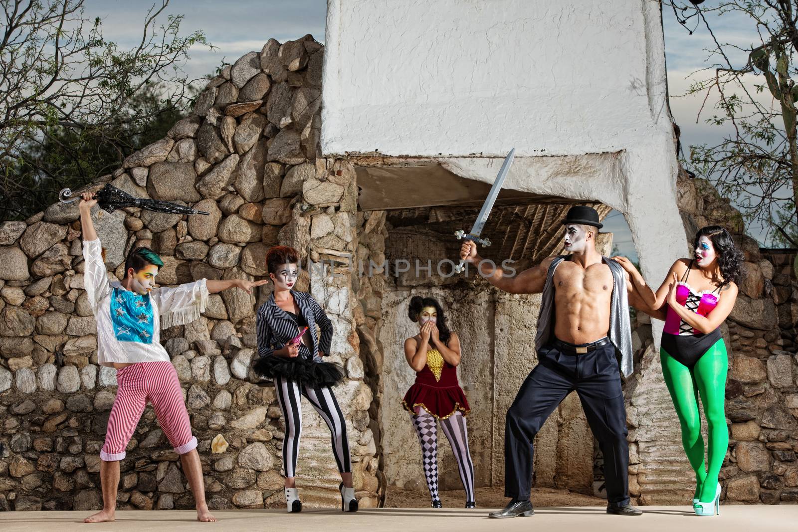 Comedia del arte ensemble in stage combat outdoors