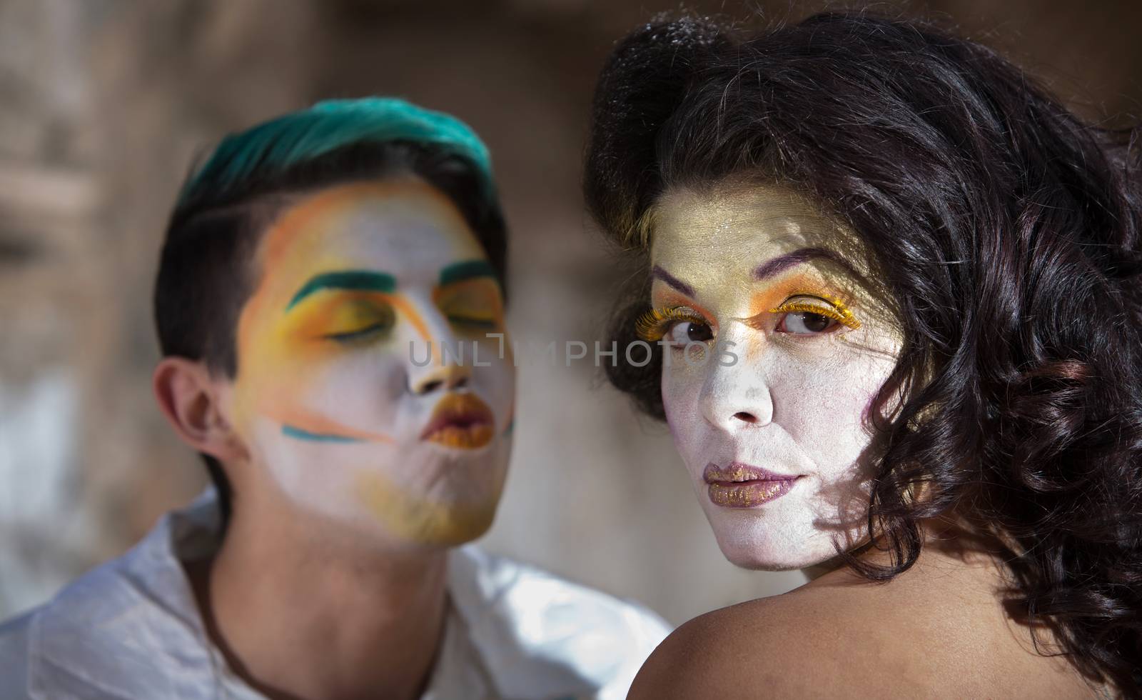 Clown trying to kiss pretty woman in cirque performance