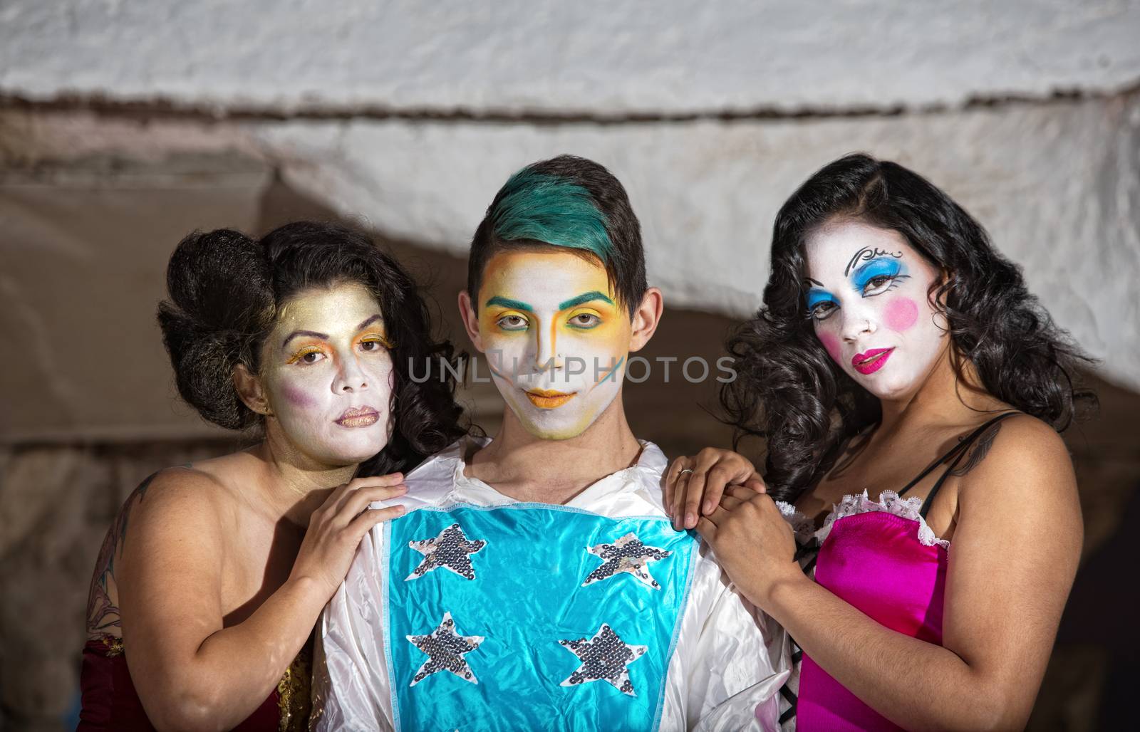 Grinning cute cirque performer with female admirers