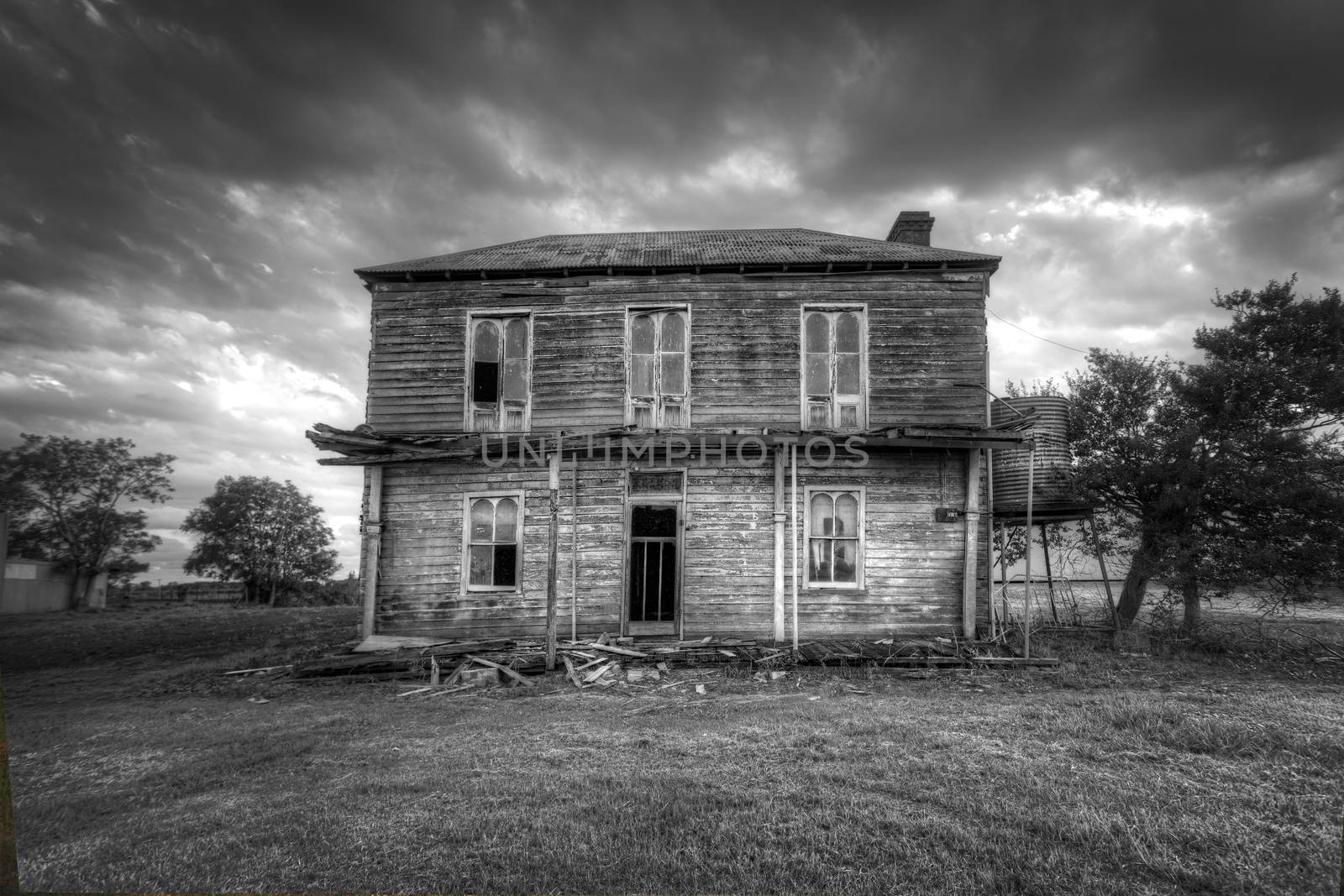 A dilapidated two storey late Victorian Georgian farm house with corrugated iron roof with attic space and corbelled brick fireplace,  no longer lived in.  It once had an upper storey verandah with fancy wrought iron lattice work.  It lies between the Hawkesbury river and the plains of Freeman's Reach. The house has survived many hardships including floods.