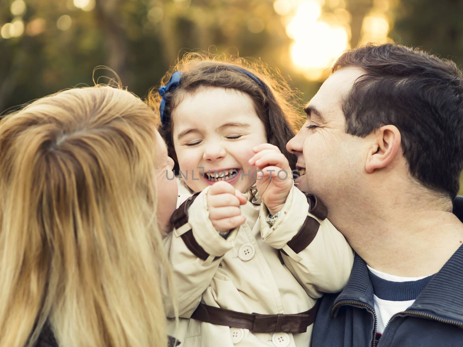 Outdoor portrait of a happy family enjoying the fall season