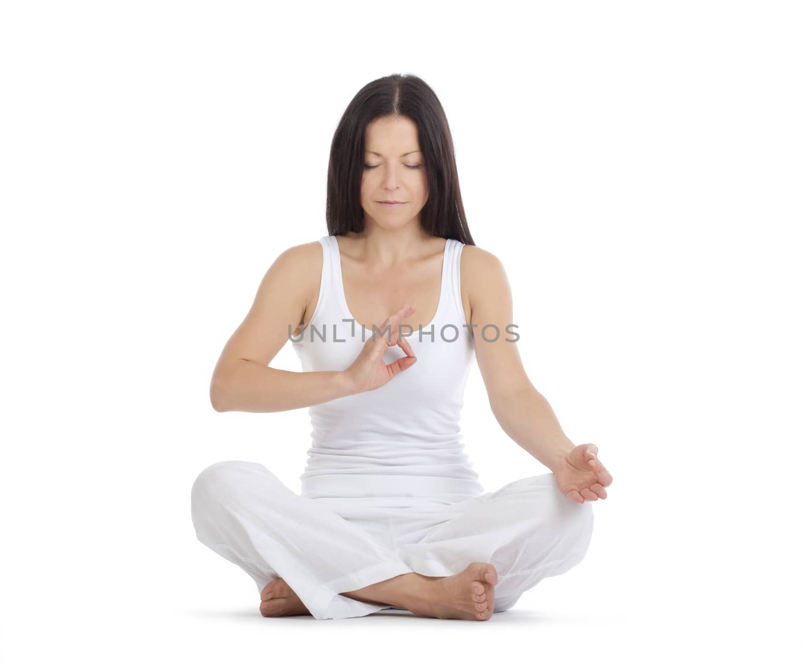 woman sitting on the floor exercising yoga - isolated on white