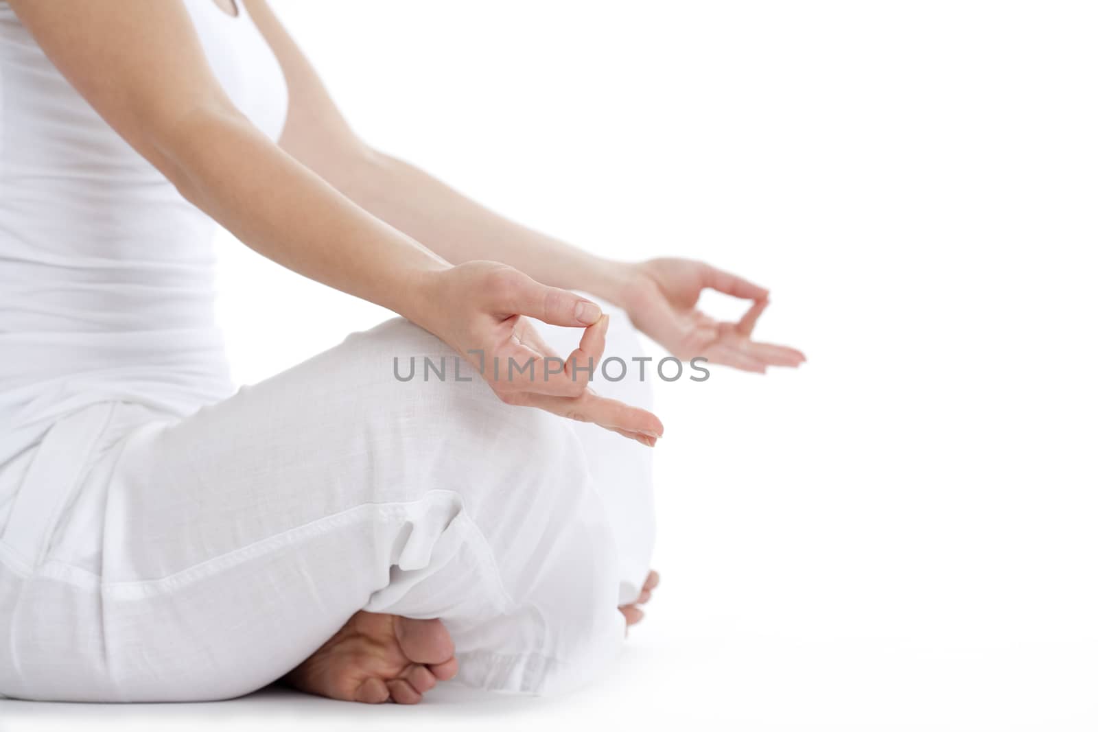 woman sitting on the floor exercising yoga - detail of hand - isolated on white