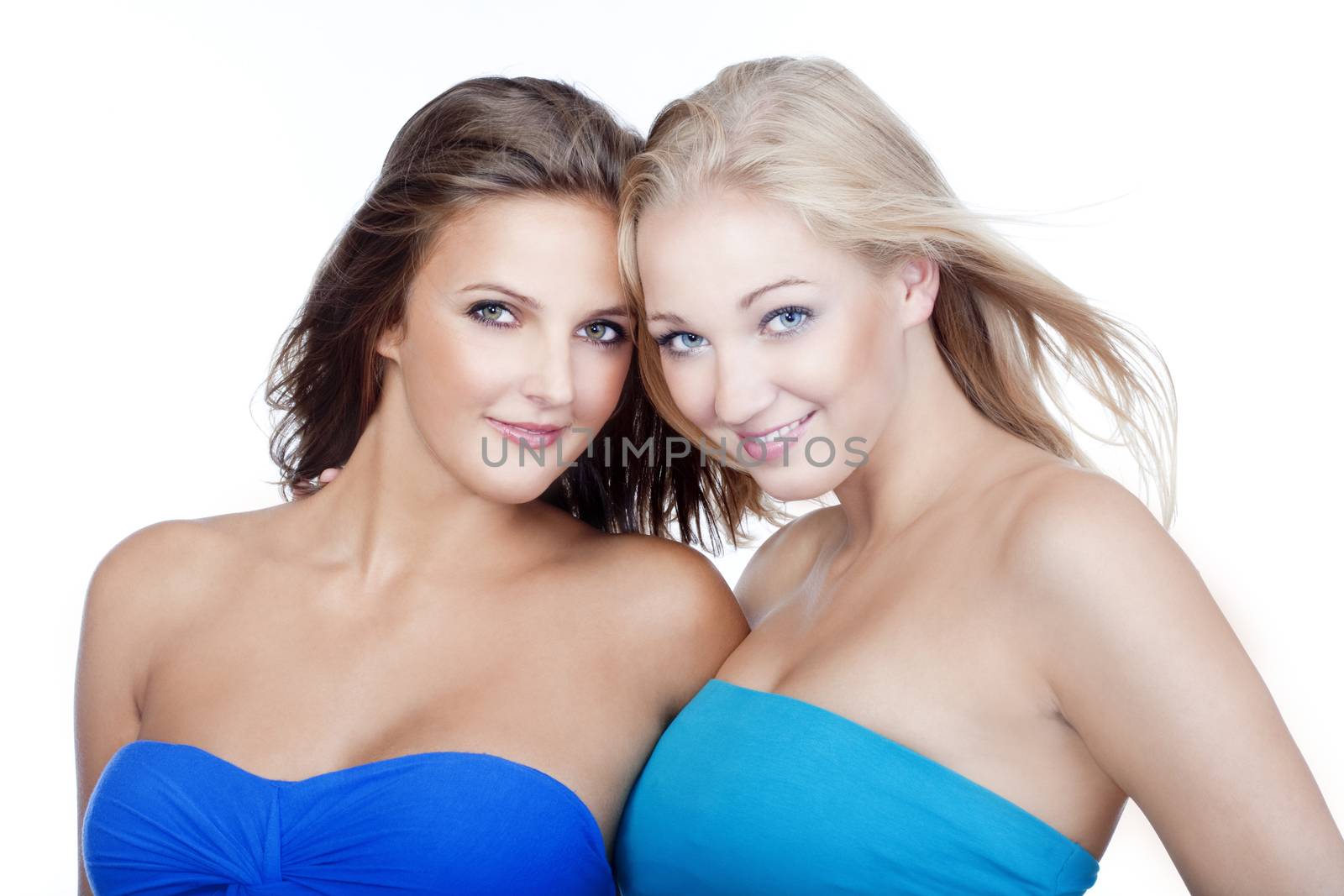 portrait of two young beautiful women smiling - isolated on white