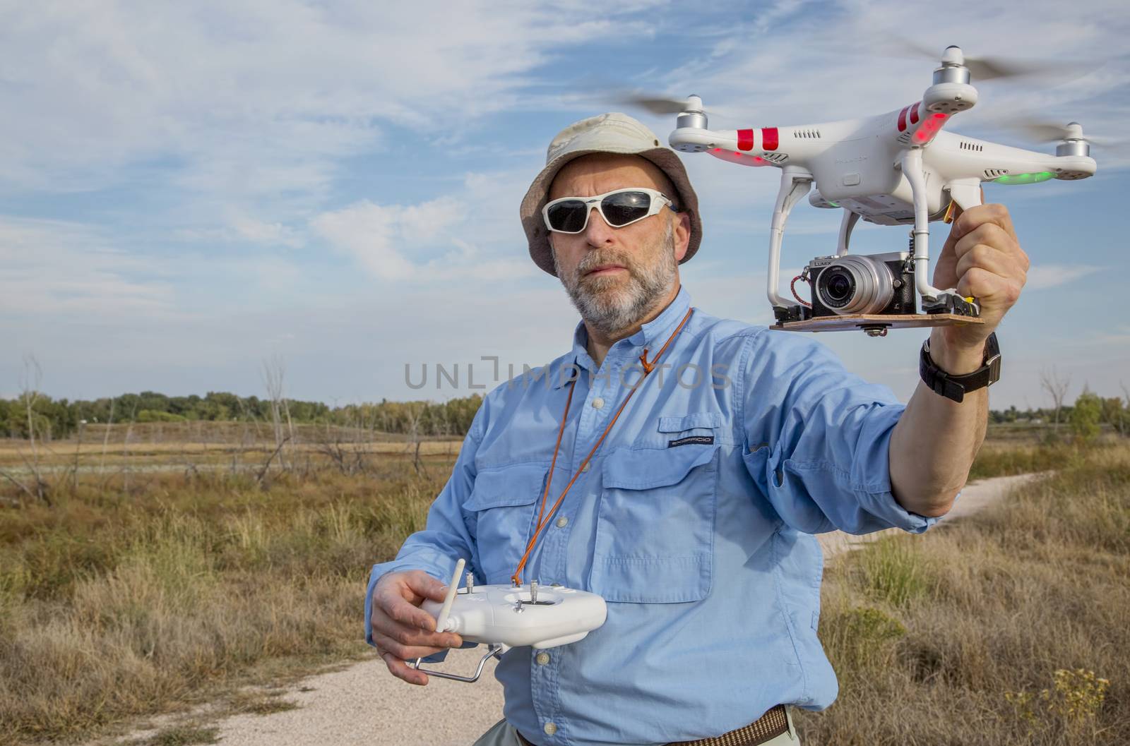 FORT COLLINS, CO, SEPTEMBER 28, 2014:  Photogrpaher, Marek Uliasz, is launching the DJI Phantom 2 quadcopter drone with Panasonic Lumix GM1 camera on board.