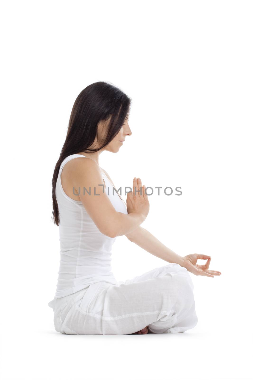 woman sitting on the floor exercising yoga - isolated on white