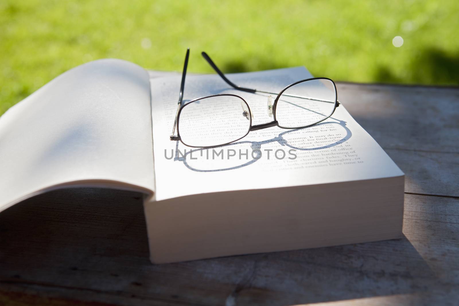 book and glasses by courtyardpix