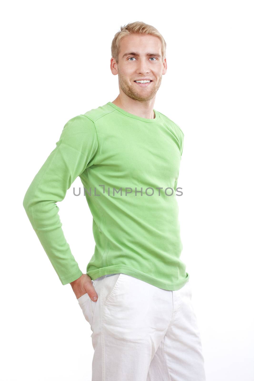 portrait of a young man with blond hair in green top smiling - isolated on white