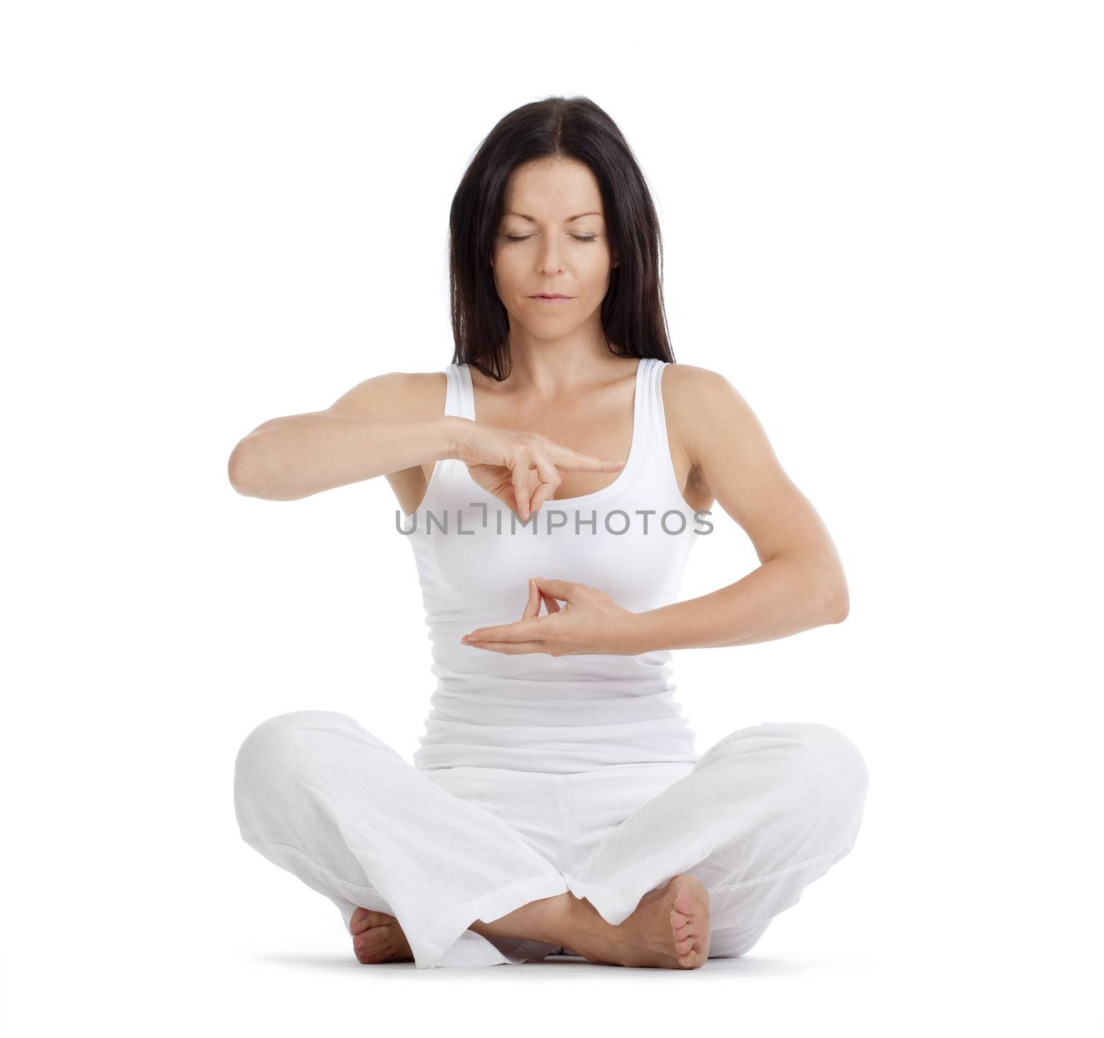 woman sitting on the floor exercising yoga - isolated on white