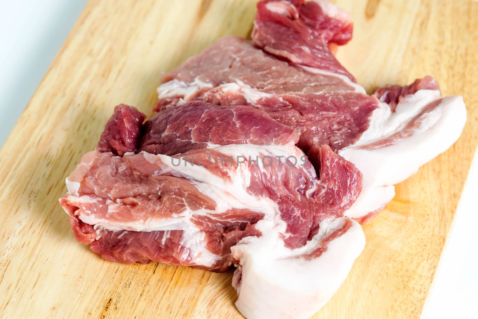 Fresh pork meat on a cutting board by Yuri2012