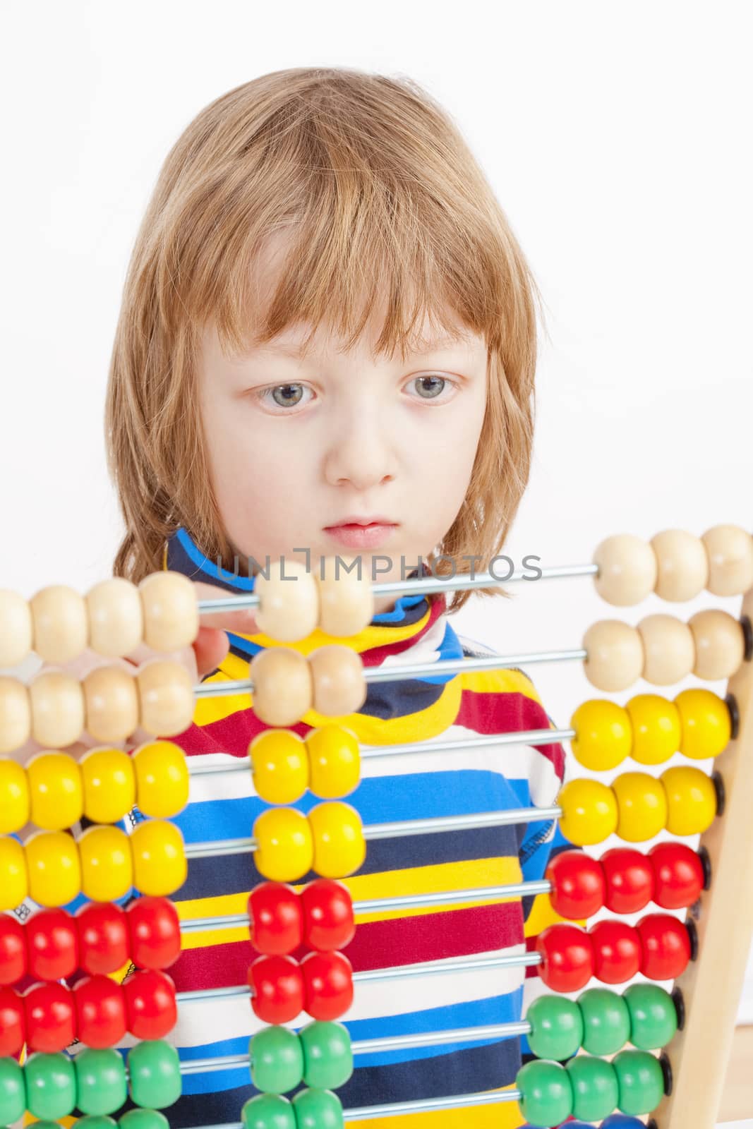 Boy Counting on Colorful Wooden Abacus - Isolated on White