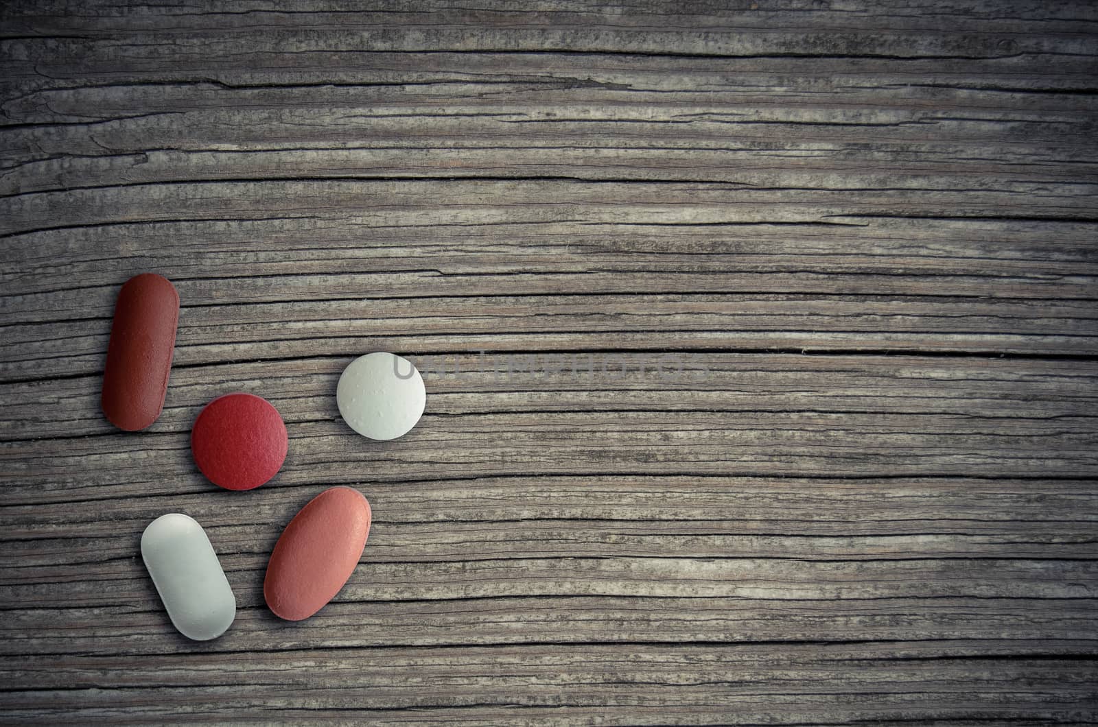 Healthcare Image Of Assorted Pills On A Wooden Table