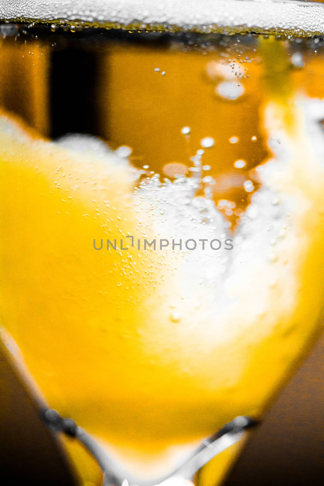 Extreme Closeup Abstract Macro Photo of Orange Mixing with Champagne for a Mimosa